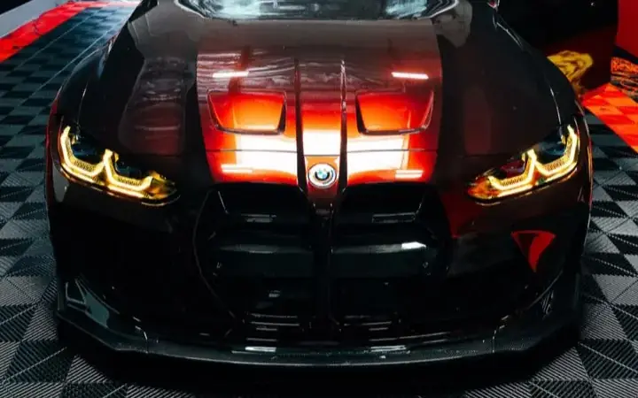 BMW M in a deep red wrap in the Most Wanted studio