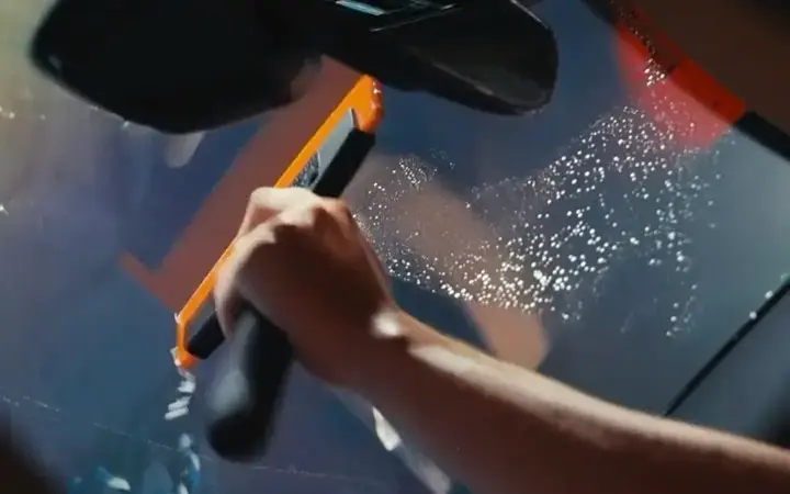 Window tint being installed on a windshield in the Most Wanted studio