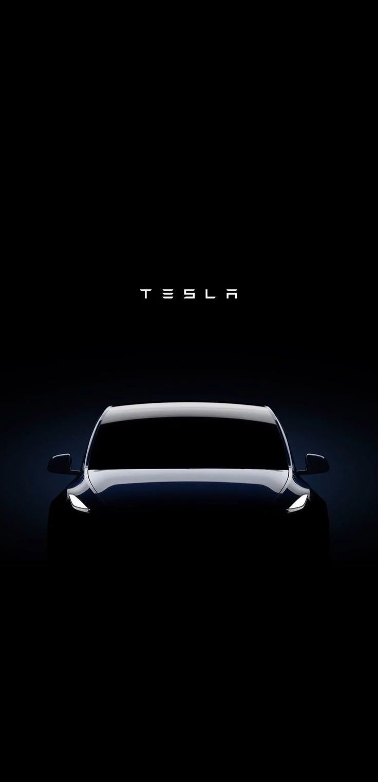 Tesla Model Y front view in the dark with headlights on