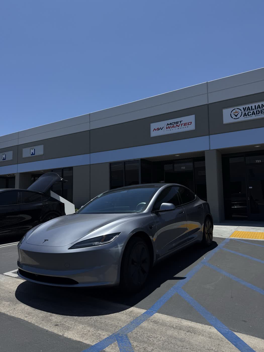 Silver Tesla Model 3 parked outside the Most Wanted studio in Santa Ana